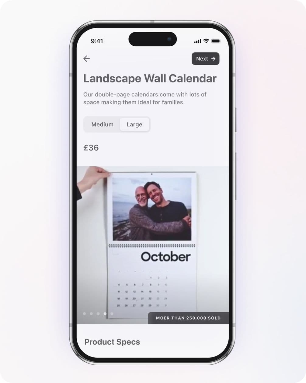 Smartphone displaying a landscape wall calendar app. October page shown with a photo of two people. Price is £36. Options for Medium and Large sizes.