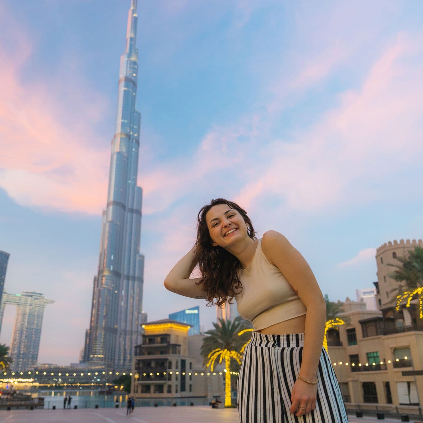 Woman smiling in front of the Burj Khalifa, Dubai, UAE