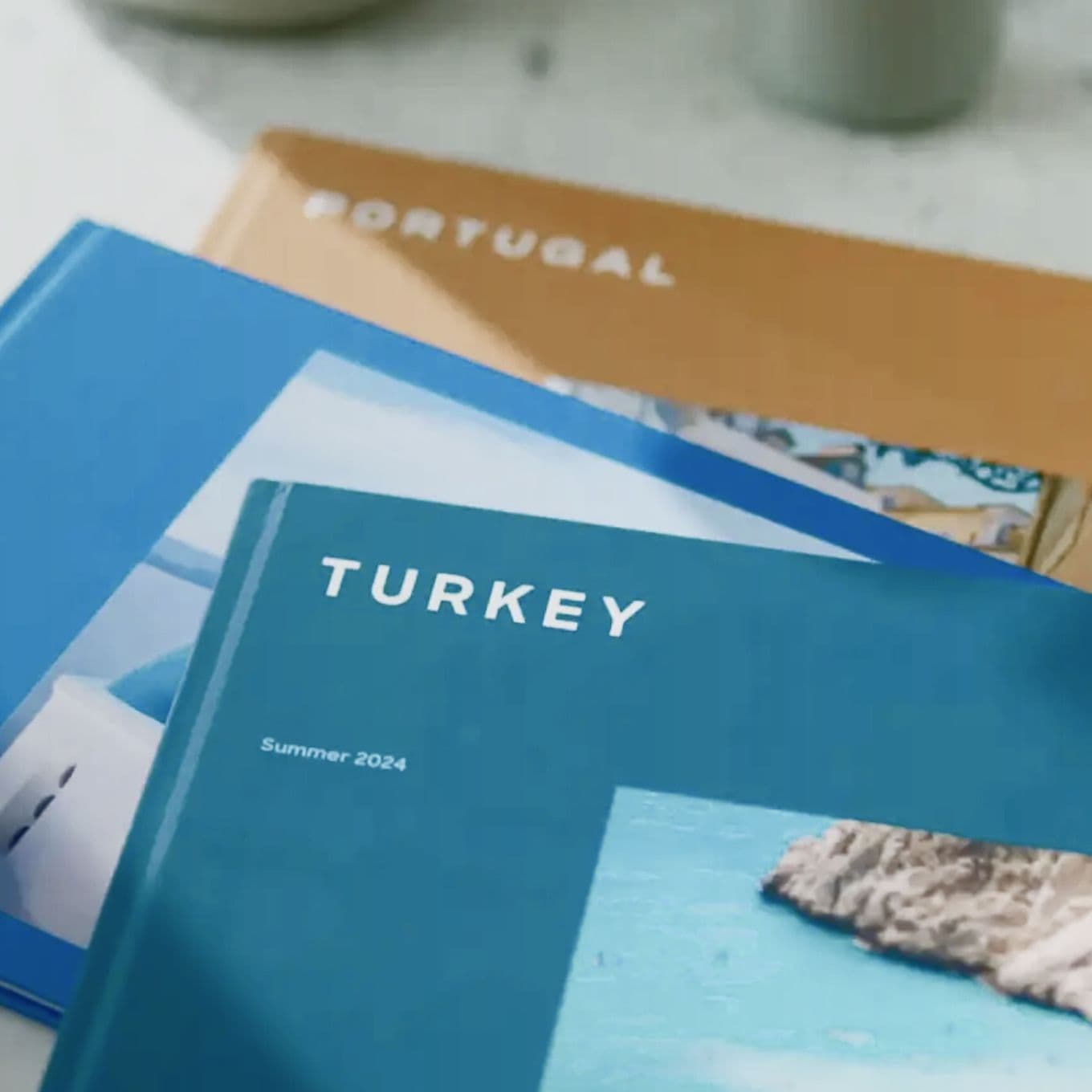 A stack of travel Photo Books from Popsa