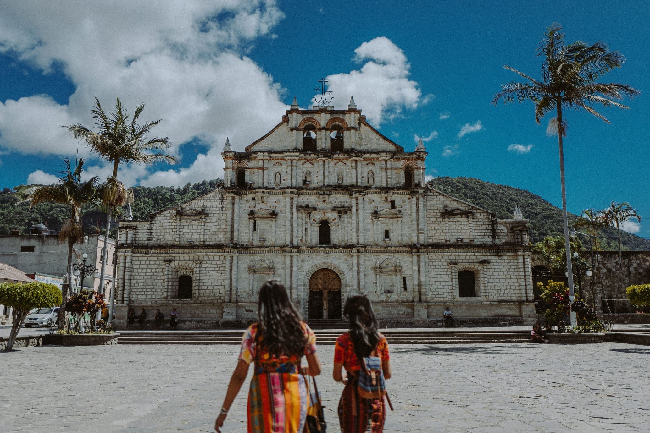Mother and daughter walk past Panajachel Church in Guatemala