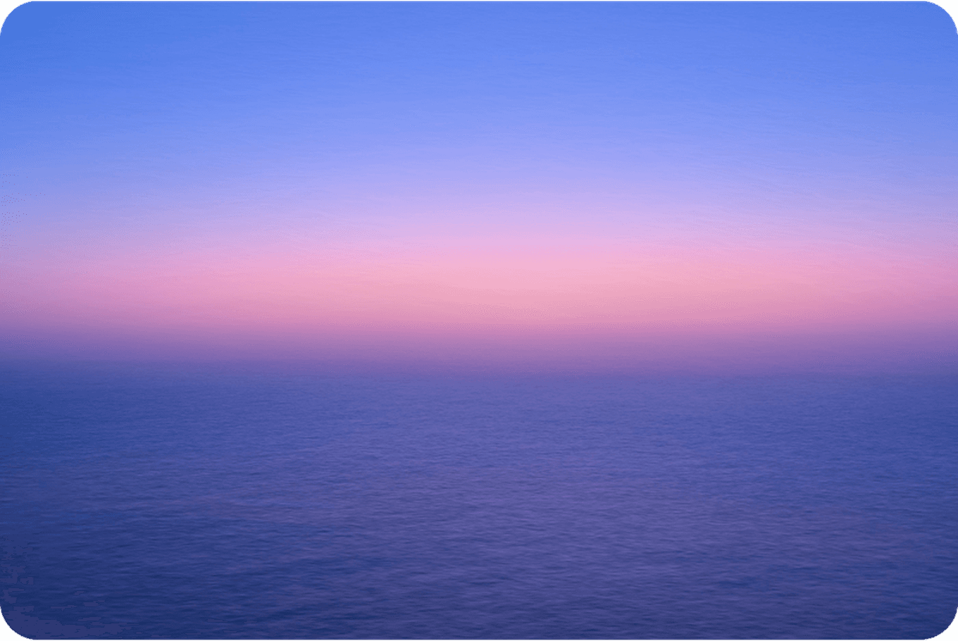 A serene ocean under a gradient sky transitioning from blue to pink at sunset, creating a tranquil and calming atmosphere.