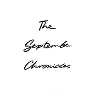 White circle with black cursive text reading "The September Chronicles."