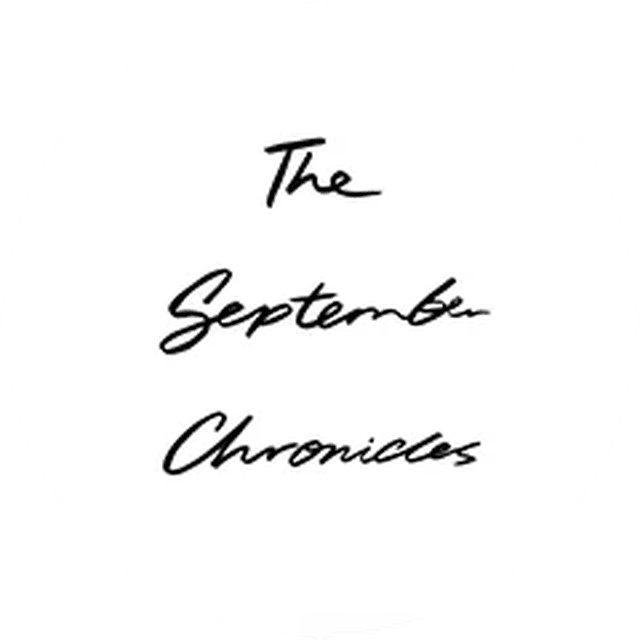 White circle with black cursive text reading "The September Chronicles."