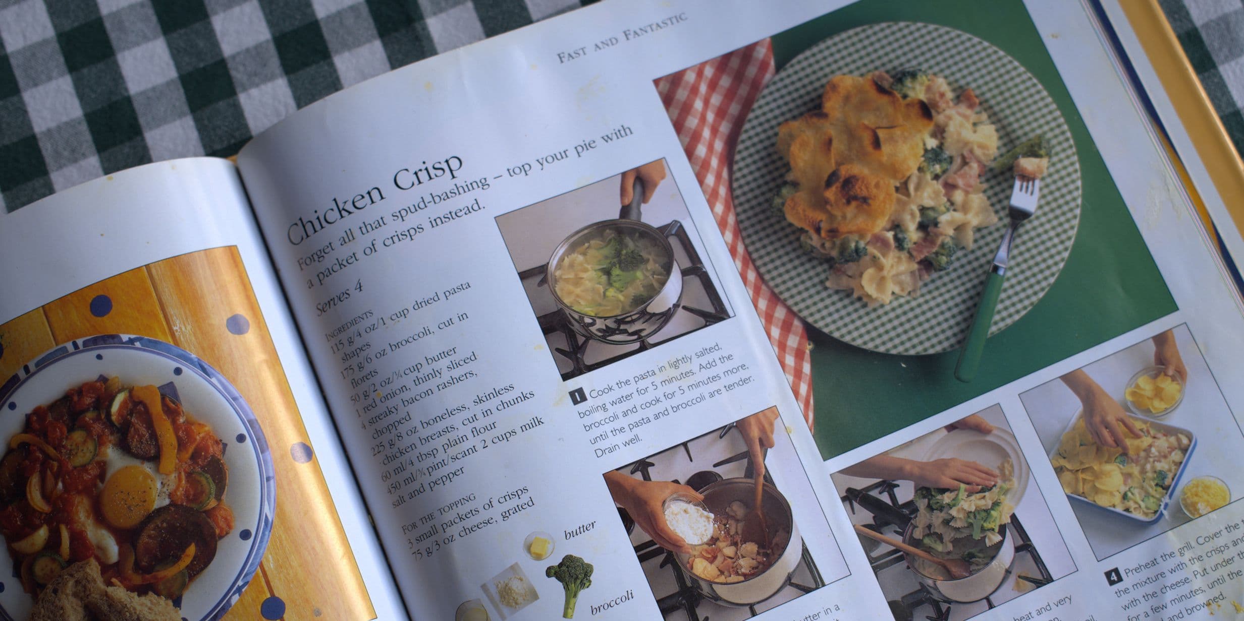 Open cookbook showing a chicken crisp recipe with steps and photos on a checkered tablecloth.