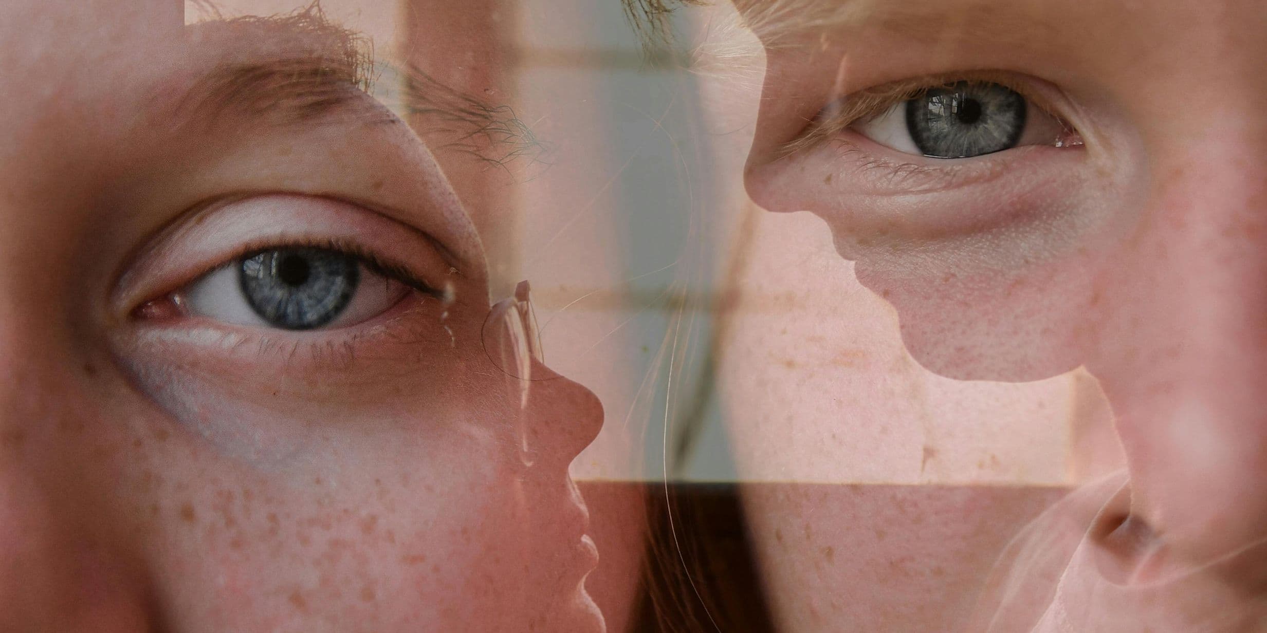 Close-up of a person's blue eyes and face, with a reflective overlay creating a layered effect.