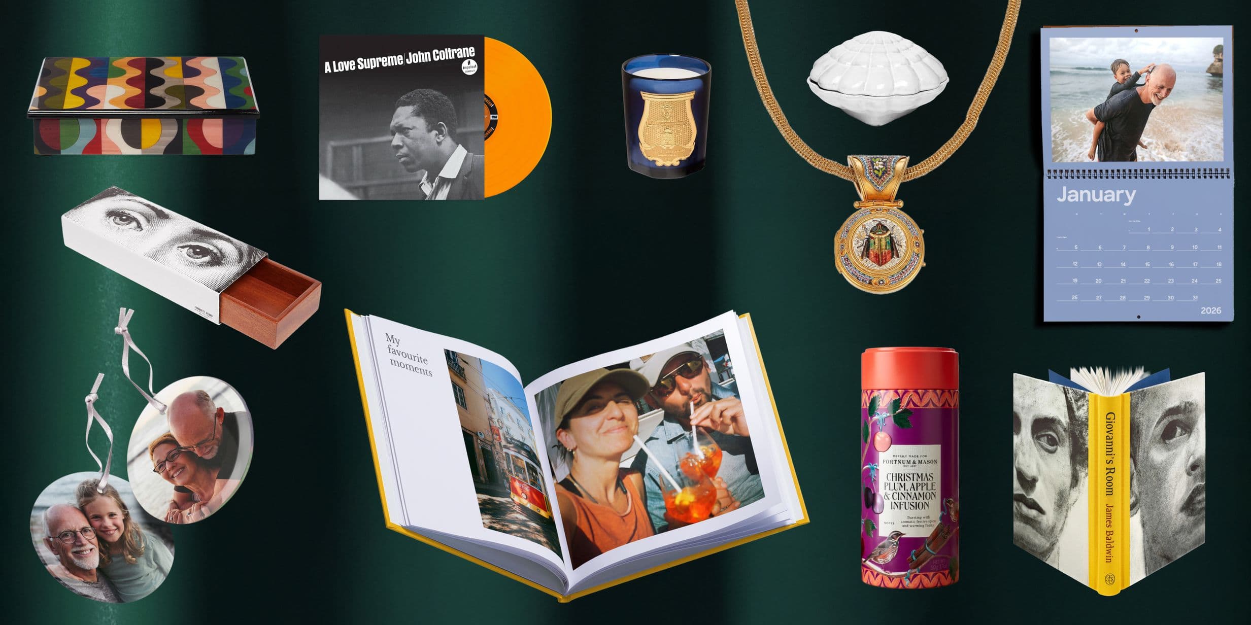 A collection of various gift items including a book, calendar, ornaments, a medal, and a record, arranged on a dark green background.