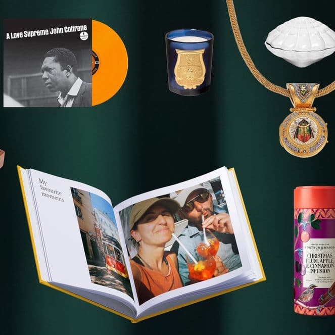 A collection of various gift items including a book, calendar, ornaments, a medal, and a record, arranged on a dark green background.