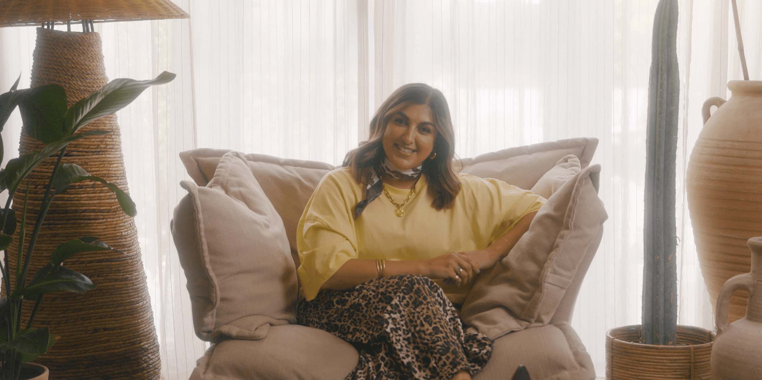 Mother of triplets Natasha Sidhu sat on an armchair