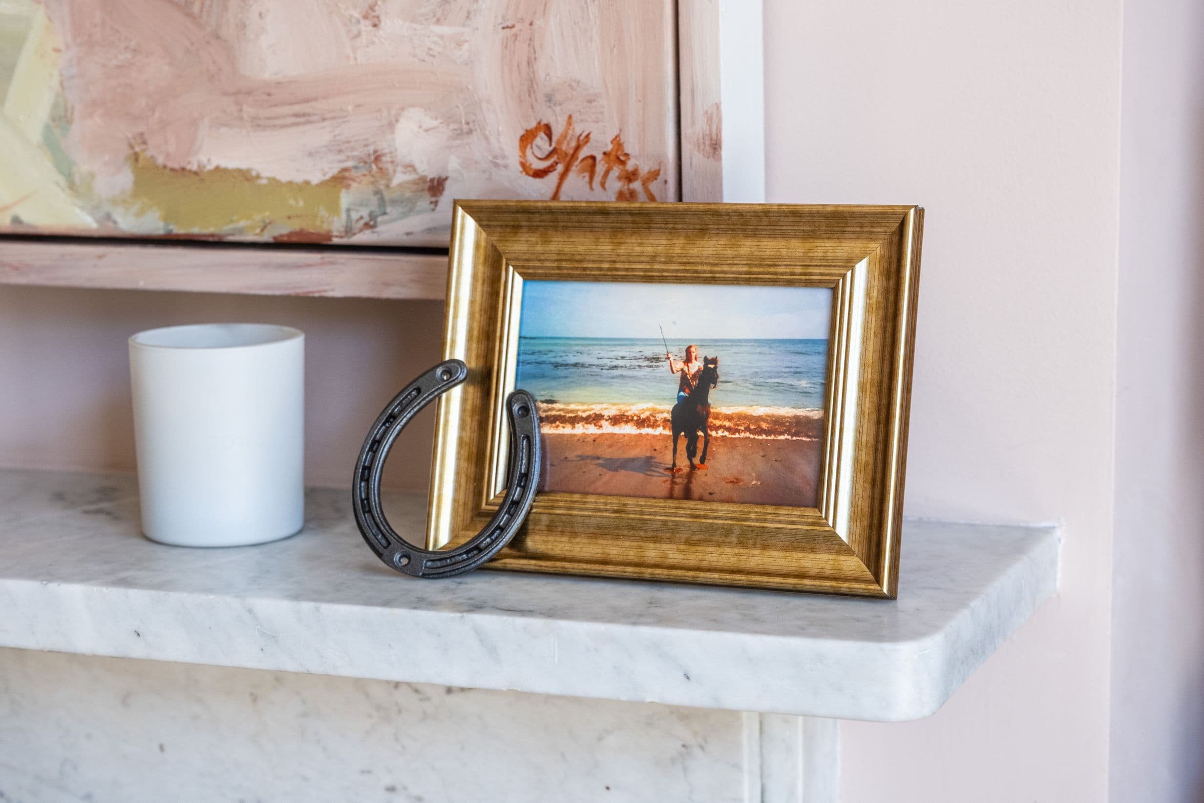 A framed photo of a young Staci Layne Wilson riding her pony, Smokey, on the beach