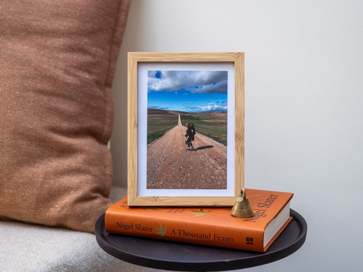 A framed bedside photo of writer Laurence Millar hiking in Camino de Santiago