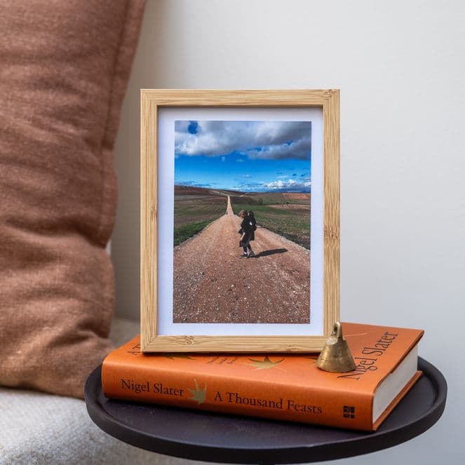 A framed bedside photo of writer Laurence Millar hiking in Camino de Santiago