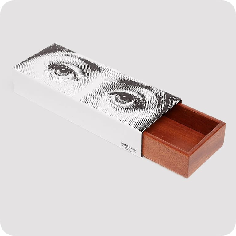 Rectangular wooden box with a sliding lid featuring a black-and-white illustration of eyes on a white background.