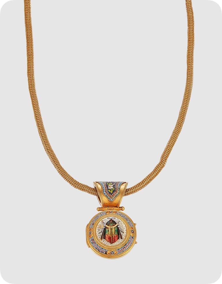 Gold necklace with a round pendant featuring a colorful religious icon. The pendant has intricate details and a decorative bail.